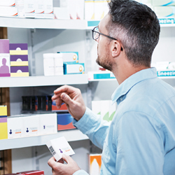 man looking at medicines