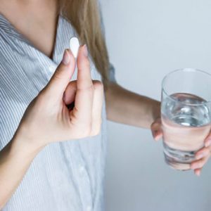 Woman taking medicine