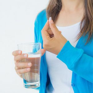 woman taking medicine