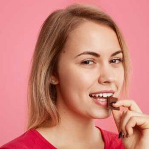 woman eating vegan chocolate